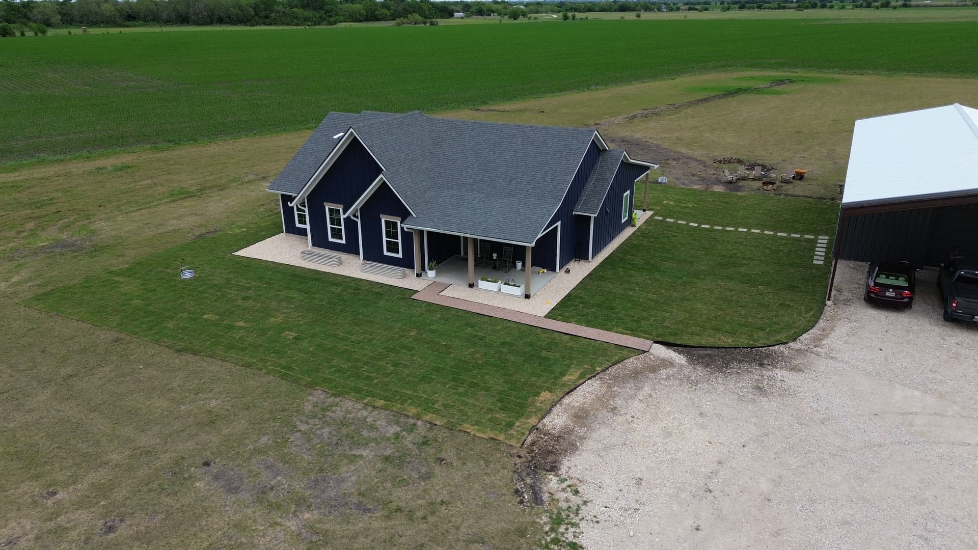 Fresh Sod Rock Beds and Retaining Walls Around a Full Home image
